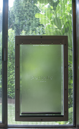 [Photo of cat door in window]